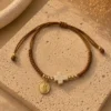 ChatGPT Image Jul 1, 2026, 04_05_26 PM Handmade Tan String Bracelet with Tan Cross