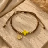 ChatGPT Image Jul 1, 2026, 04_07_02 PM Handmade Tan String Bracelet with Yellow Cross