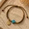 ChatGPT Image Jul 5, 2026, 08_41_35 PM Handmade Tan String Bracelet with Aqua Cross